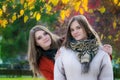 Portrait two beautiful girlfriends on a sunny autumn day Royalty Free Stock Photo