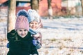 Portrait of two sisters of different ages on a winter walk in a snowy park Royalty Free Stock Photo