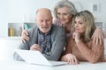 Portrait of two senior women and man using laptop Royalty Free Stock Photo