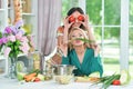 Two beautiful young women cooking together in kitchen Royalty Free Stock Photo