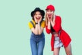 Portrait of two best friend beautiful amazing happy fashionable hipster girls standing and screaming with unbelievable face,