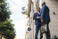 Portrait of two black African American businessman in suits shake hands outdoors. The joy of meeting good friends Royalty Free Stock Photo