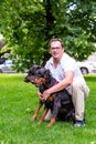 Two black dobermans. Man walks in the park two pureblood Dobermanns Royalty Free Stock Photo