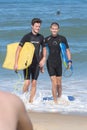 Portrait two boys bodyboarding