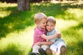 Portrait of two boys embracing and laughing outdoors Royalty Free Stock Photo