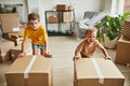 Boys Moving Boxes in New House