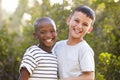 Portrait of two boys outdoors laughing and looking to camera Royalty Free Stock Photo