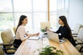 Portrait of two business woman working in office with computer. Royalty Free Stock Photo