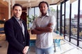 Portrait Of Two Businessmen Standing In Modern Open Plan Office Together Royalty Free Stock Photo