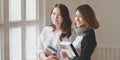 Portrait of two businesswoman looking of the windows in modern room Royalty Free Stock Photo