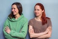 Portrait of two Caucasian women, standing together with folded arms Royalty Free Stock Photo