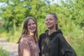 Portrait of two charming young girls, outdoors, in garden close up Royalty Free Stock Photo