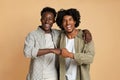 Portrait Of Two Cheerful Black Guys Embracing And Making Fist Bump Gesture Royalty Free Stock Photo