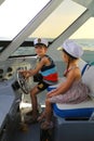 Portrait of children driving a yacht