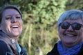 A portrait of two collegue ladies in the nature laughing