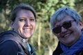 A portrait of two smiling collegue ladies in the nature