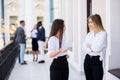 Portrait of two confident businesswomen in formalwear looking forwards in front of business team Royalty Free Stock Photo
