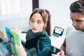 Portrait of two coworker people standing at office space behind glass wall with sticky notes Royalty Free Stock Photo