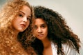 Portrait of two curly girls. Afro and blond Royalty Free Stock Photo