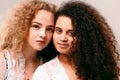 Portrait of two curly girls. Afro and blond Royalty Free Stock Photo