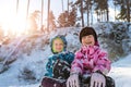 Portrait of two cute adorable little playful children wearing warm snow jacket enjoy having fun playing at park outdoors Royalty Free Stock Photo