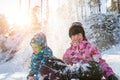 Portrait of two cute adorable little playful children wearing warm snow jacket enjoy having fun playing at park outdoors Royalty Free Stock Photo