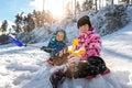 Portrait of two cute adorable little playful children wearing warm snow jacket enjoy having fun playing at park outdoors Royalty Free Stock Photo