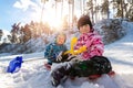 Portrait of two cute adorable little playful children wearing warm snow jacket enjoy having fun playing at park outdoors Royalty Free Stock Photo