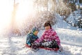 Portrait of two cute adorable little playful children wearing warm snow jacket enjoy having fun playing at park outdoors Royalty Free Stock Photo