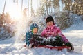 Portrait of two cute adorable little playful children wearing warm snow jacket enjoy having fun playing at park outdoors Royalty Free Stock Photo