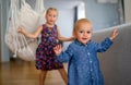 Portrait of two cute little children girls playing and having fun in the kids room Royalty Free Stock Photo