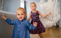 Portrait of two cute little children girls playing and having fun in the kids room Royalty Free Stock Photo