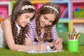 Portrait of two cute little girls drawing with pencils Royalty Free Stock Photo