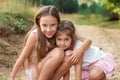 Portrait of Two Cute little girls embracing and laughing at the forest. Happy kids outdoors Royalty Free Stock Photo