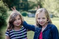 Portrait of two cute little girls enjoying summer outdoors. Royalty Free Stock Photo
