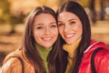 Portrait of two cute pretty girls best friends tourists enjoy nature autumn rest relax look good in camera wear season