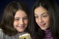 Portrait of two cute sisters looking at cell phone Royalty Free Stock Photo