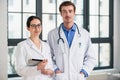 Two dedicated doctors smiling at camera