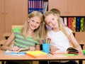 Portrait of two diligent girls looking at camera at workplace Royalty Free Stock Photo