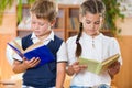 Portrait of two diligent pupil with books