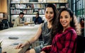 Portrait of two diverse beautiful Asian and Caucasian women wearing casual clothes for working, smiling with happiness, confidence Royalty Free Stock Photo