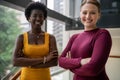 Diverse young businesswomen smiling while standing together in an office Royalty Free Stock Photo