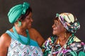 Portrait of two elderly African American sisters looking at each other affectionately Royalty Free Stock Photo