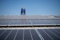 Portrait of two engineers working on a photovoltaic solar panels, Royalty Free Stock Photo