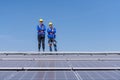 Portrait of two engineers working on a photovoltaic solar panels, Royalty Free Stock Photo