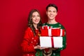 Portrait of two excited positive people hold pile stack festive giftbox isolated on red color background