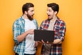 Portrait of a two excited young men holding laptop Royalty Free Stock Photo