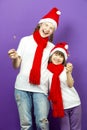 Portrait of Two Expressive Laughing Caucasian Sisters Girls in Seasonal Warm Clothing Having Fun With Vivid Bright Burning Bengal