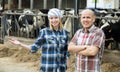 Portrait of two farmers near cows barn