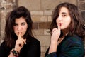 Portrait two female friends silencing finger mouth Royalty Free Stock Photo